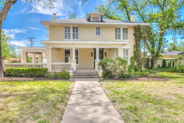 view of front of house with a front yard and a porch