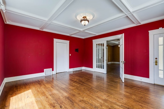 spare room with french doors, coffered ceiling, beam ceiling, and hardwood / wood-style flooring