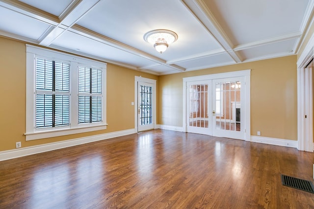 spare room featuring coffered ceiling, french doors, and a healthy amount of sunlight