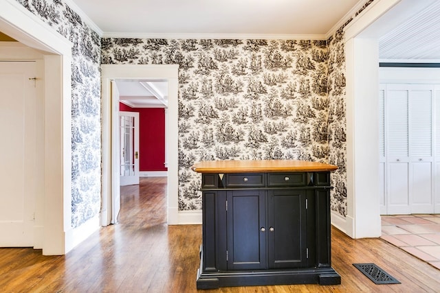 interior space with crown molding and dark wood-type flooring