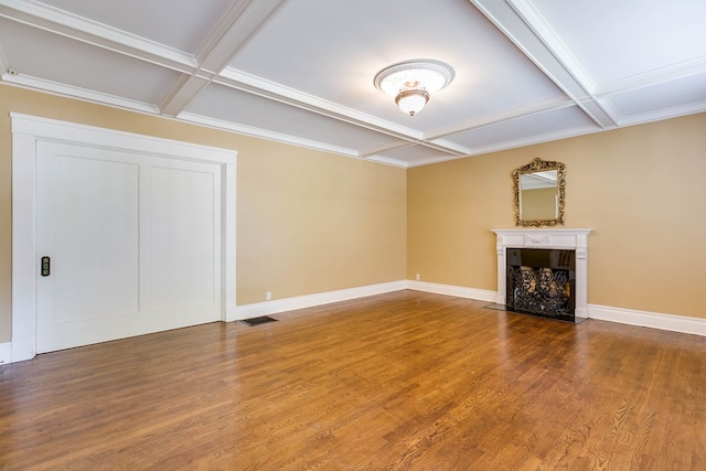 unfurnished living room featuring hardwood / wood-style flooring, coffered ceiling, and beamed ceiling