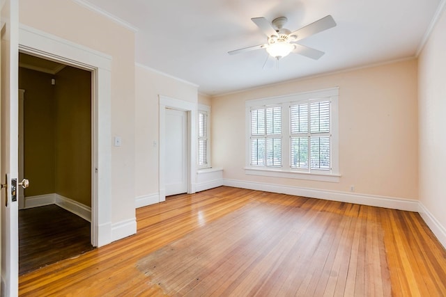 spare room featuring crown molding, hardwood / wood-style floors, and ceiling fan