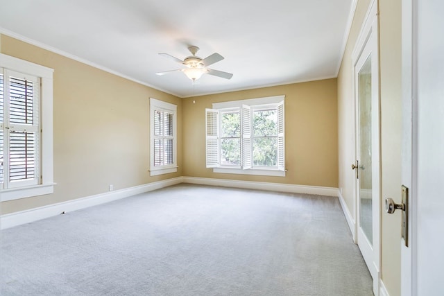 carpeted empty room featuring ceiling fan and ornamental molding