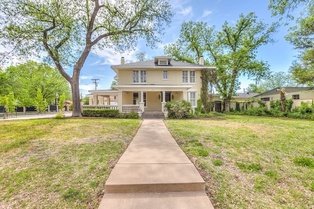 view of front of property with covered porch and a front yard