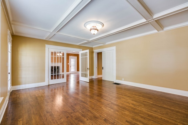 empty room with an inviting chandelier, coffered ceiling, dark hardwood / wood-style flooring, french doors, and beamed ceiling