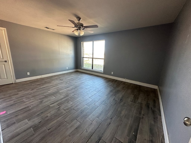 spare room featuring dark hardwood / wood-style floors and ceiling fan