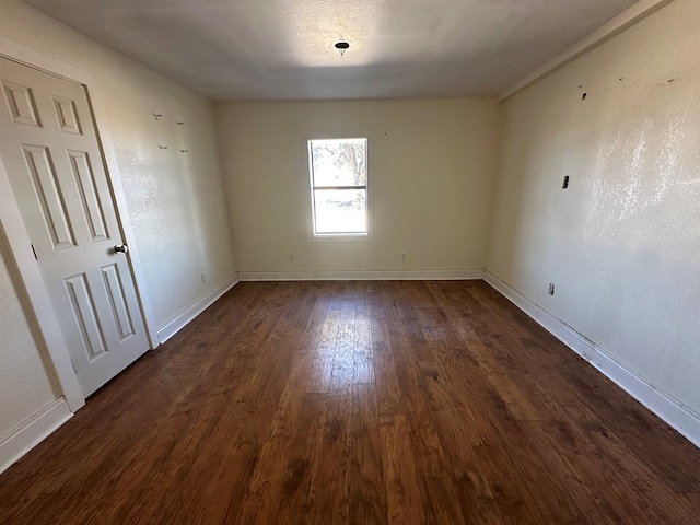 spare room with dark hardwood / wood-style flooring