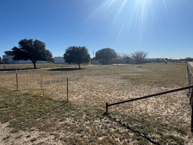 view of yard with a rural view