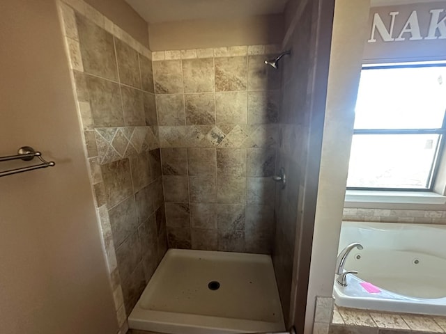 bathroom featuring shower with separate bathtub