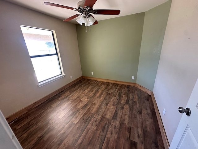 unfurnished room with dark wood-type flooring and ceiling fan