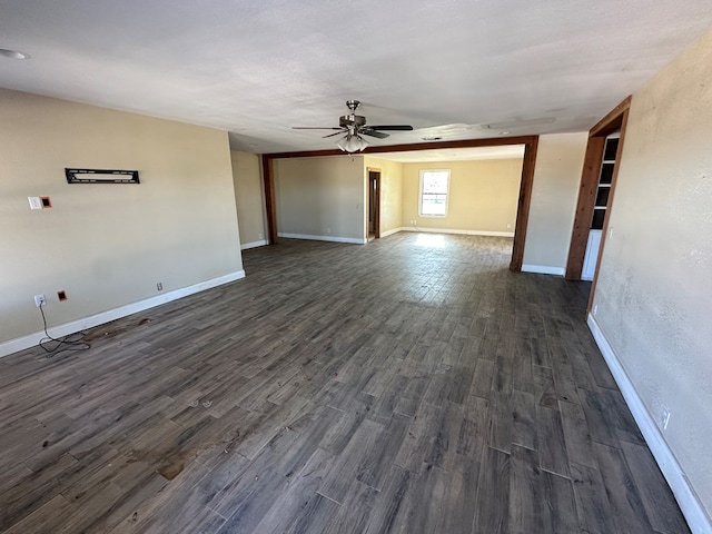 empty room featuring dark hardwood / wood-style flooring and ceiling fan