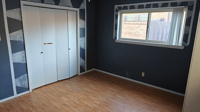 unfurnished bedroom featuring baseboards and wood finished floors