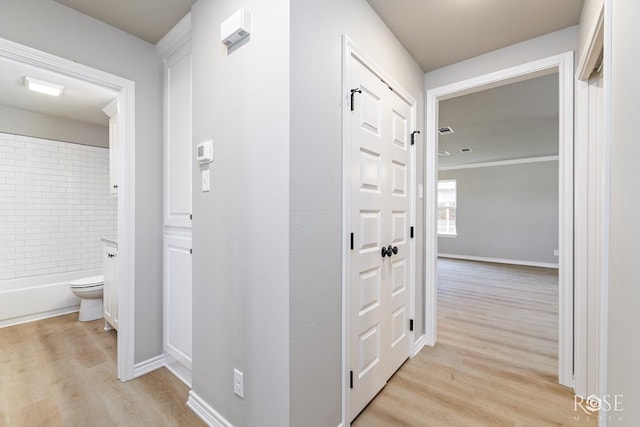 hall with light hardwood / wood-style flooring