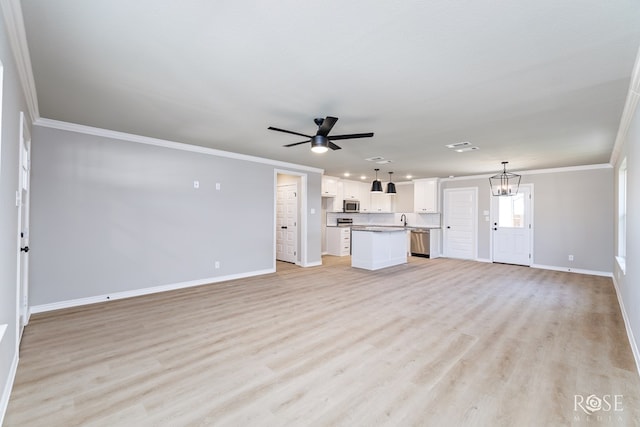 unfurnished living room featuring ceiling fan with notable chandelier, ornamental molding, and light hardwood / wood-style floors