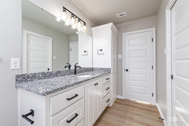 bathroom featuring wood-type flooring and vanity