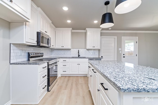 kitchen featuring stainless steel appliances and white cabinets