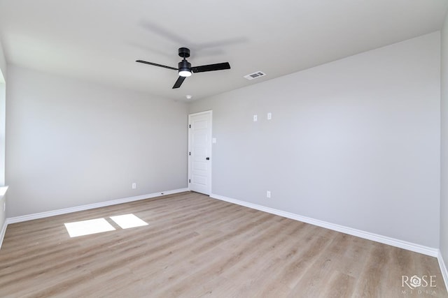 spare room with ceiling fan and light wood-type flooring