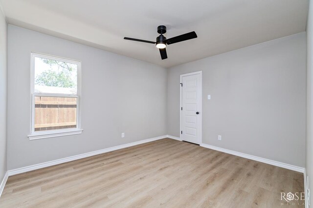 empty room featuring ceiling fan and light wood-type flooring