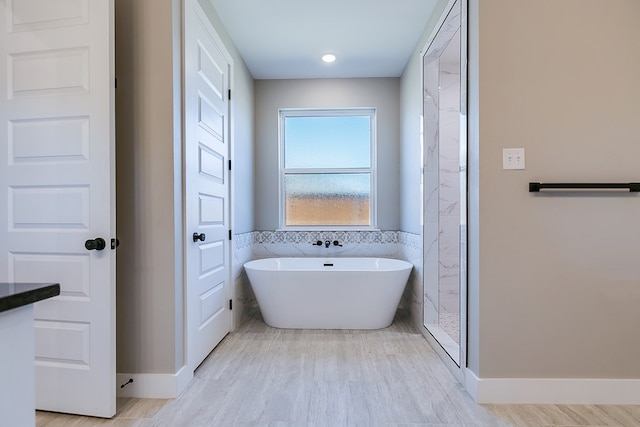 bathroom featuring wood-type flooring and a washtub