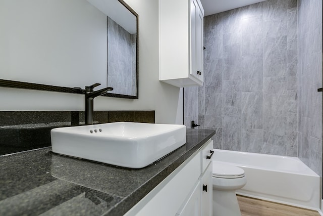 full bathroom with vanity, toilet, shower / washtub combination, and wood-type flooring