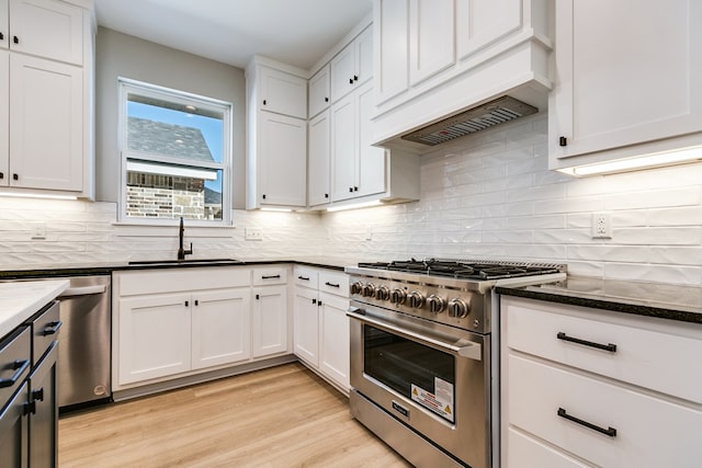 kitchen with sink, stainless steel appliances, light hardwood / wood-style floors, and white cabinets