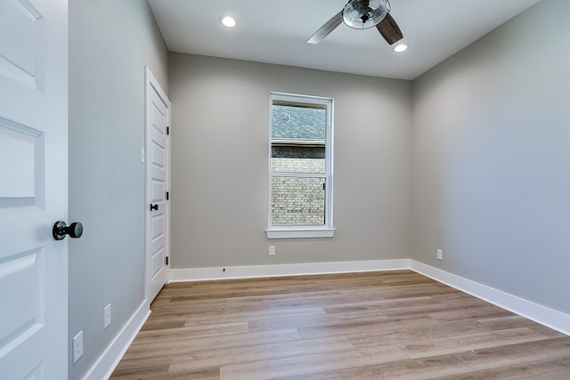 unfurnished room featuring plenty of natural light, ceiling fan, and light wood-type flooring