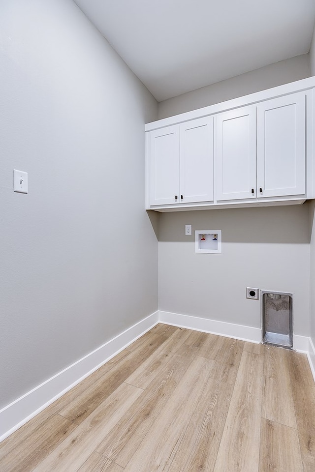 washroom with cabinets, washer hookup, hookup for an electric dryer, and light hardwood / wood-style floors