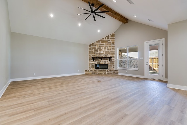 unfurnished living room featuring beam ceiling, high vaulted ceiling, light wood-type flooring, ceiling fan, and a fireplace