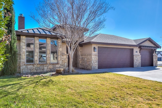 view of front of home with a garage and a front lawn