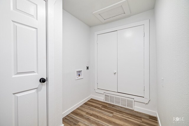 935 E 40th St, San Angelo, TX 76903 - laundry room featuring hookup for a washing machine, attic access, wood finished floors, and hookup for an electric dryer