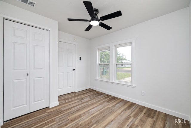 935 E 40th St, San Angelo, TX 76903 - unfurnished bedroom featuring light wood finished floors, a closet, and a ceiling fan