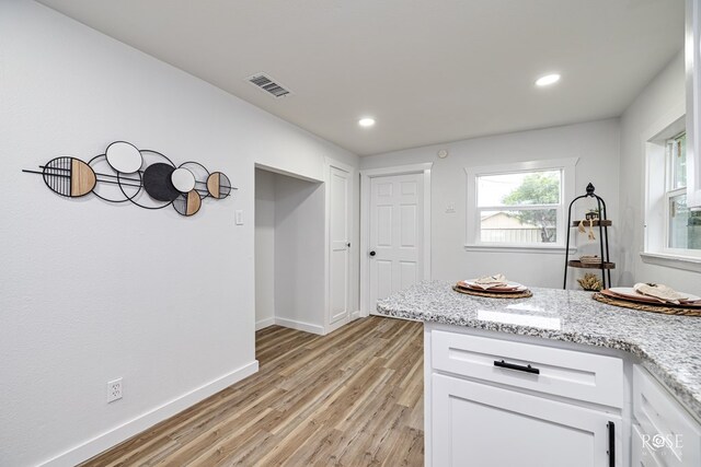935 E 40th St, San Angelo, TX 76903 - kitchen featuring light wood-style flooring, white cabinetry, recessed lighting, and light stone countertops
