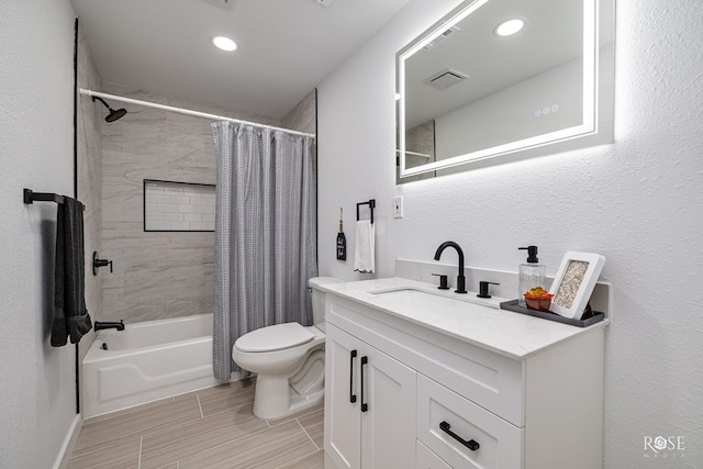 935 E 40th St, San Angelo, TX 76903 - bathroom featuring shower / tub combo, vanity, recessed lighting, and a textured wall