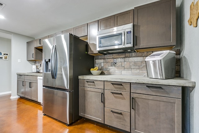 718 E 45th St, San Angelo, TX 76903 - kitchen with stainless steel appliances, tasteful backsplash, finished concrete floors, and light stone counters