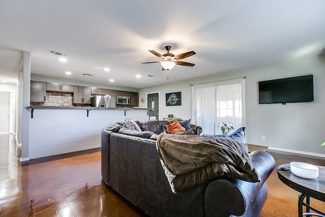 718 E 45th St, San Angelo, TX 76903 - living room featuring ceiling fan, recessed lighting, and concrete floors