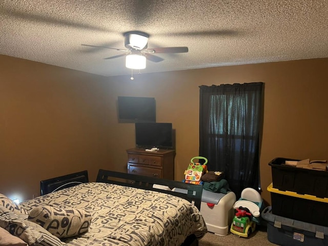 bedroom featuring a textured ceiling, carpet floors, and ceiling fan