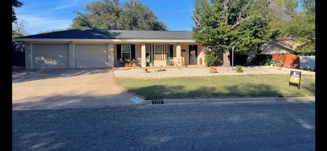 ranch-style house with a garage and a front yard