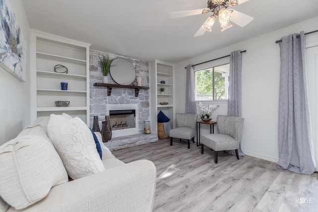 286 Mockingbird Ln, San Angelo, TX 76901 - living area with wood finished floors, a fireplace, a ceiling fan, and built in features