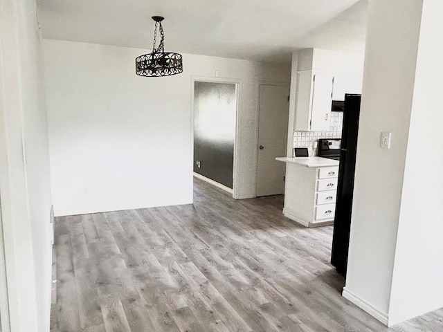 286 Mockingbird Ln, San Angelo, TX 76901 - unfurnished dining area featuring light wood-style flooring and baseboards