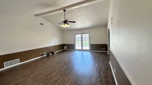 spare room with vaulted ceiling with beams, dark hardwood / wood-style floors, ceiling fan, and french doors