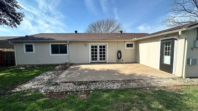 rear view of house featuring a patio and a lawn