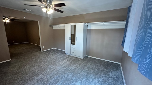 unfurnished bedroom featuring ceiling fan and dark colored carpet