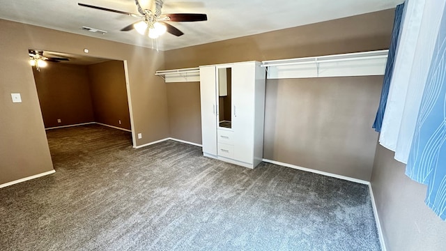 unfurnished bedroom with ceiling fan and dark colored carpet