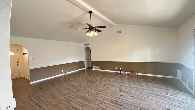 interior space with ceiling fan, wood-type flooring, and vaulted ceiling with beams