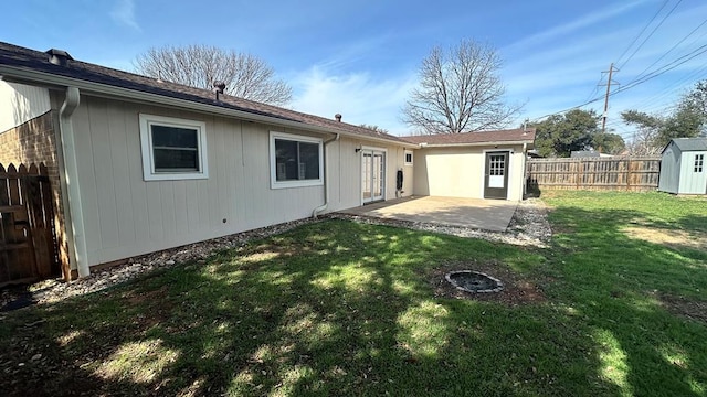 back of house with a patio area and a lawn