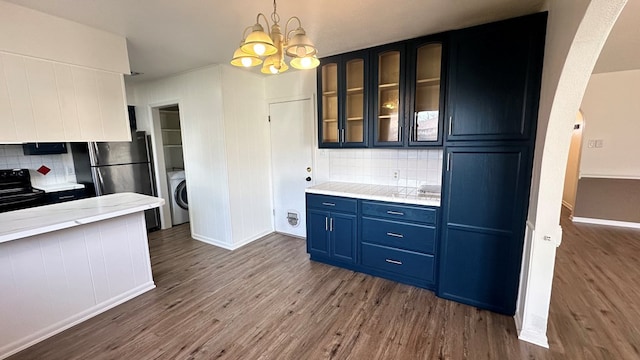 kitchen with blue cabinetry, washer / dryer, decorative light fixtures, dark hardwood / wood-style floors, and black range with electric stovetop