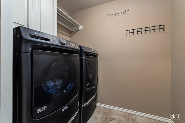 laundry area with cabinets and washing machine and clothes dryer