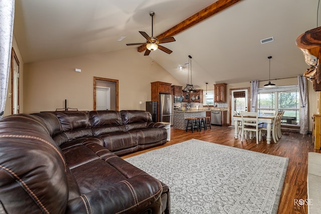 living room featuring dark wood-type flooring, vaulted ceiling with beams, and ceiling fan