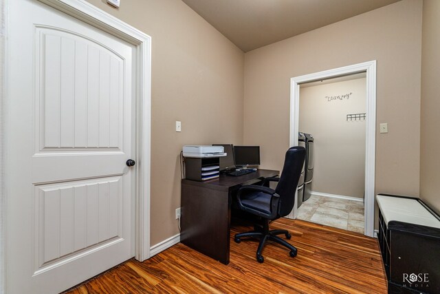 home office with hardwood / wood-style flooring