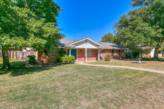 single story home featuring a porch and a front yard